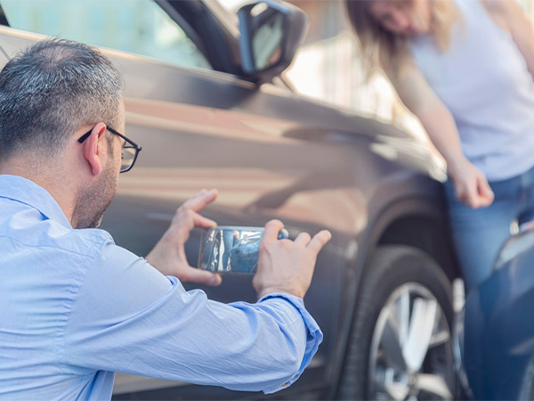 a person taking a photo of a car accident